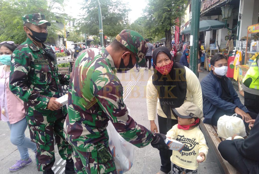 Aparat TNI membagikan masker dan Face Shield kepada masyarakat Yogyakarta dalam kegiatan Malioboro Berface Shield, Minggu (18/10/2020). / ft - dok/polresta